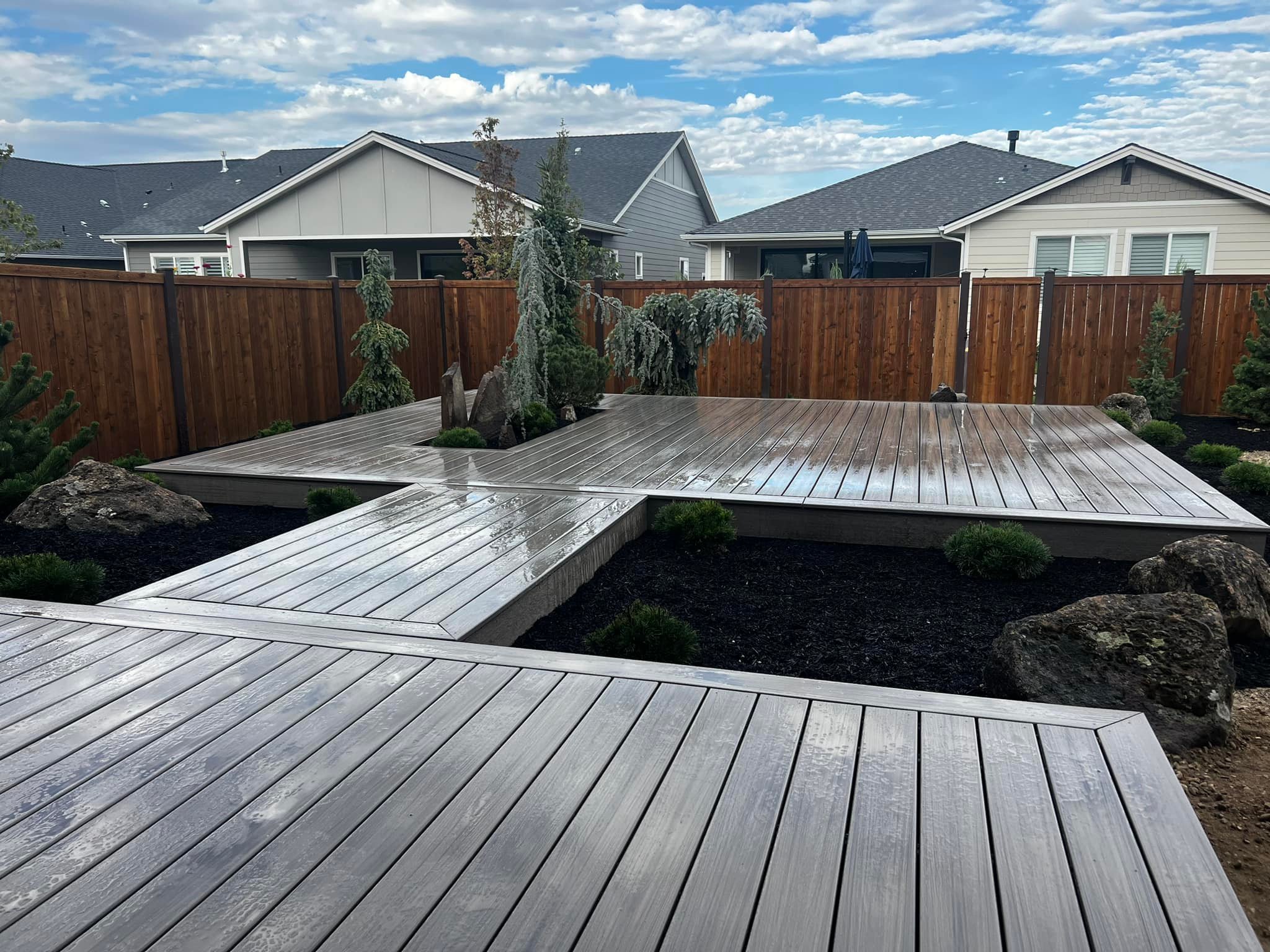 Composite deck and landscaped backyard by Fox Landscape